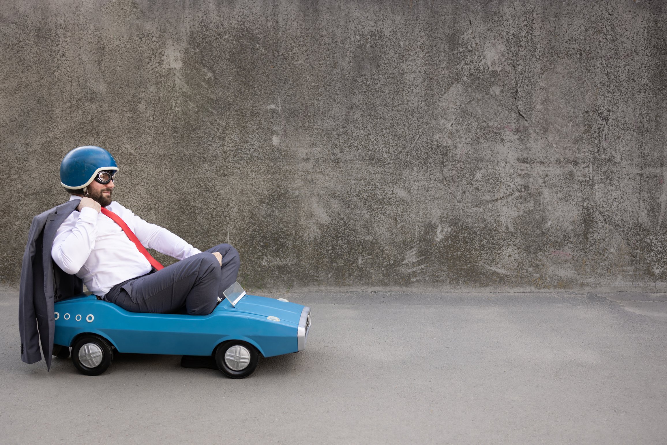 Funny Businessman Driving Retro Pedal Car Outdoor